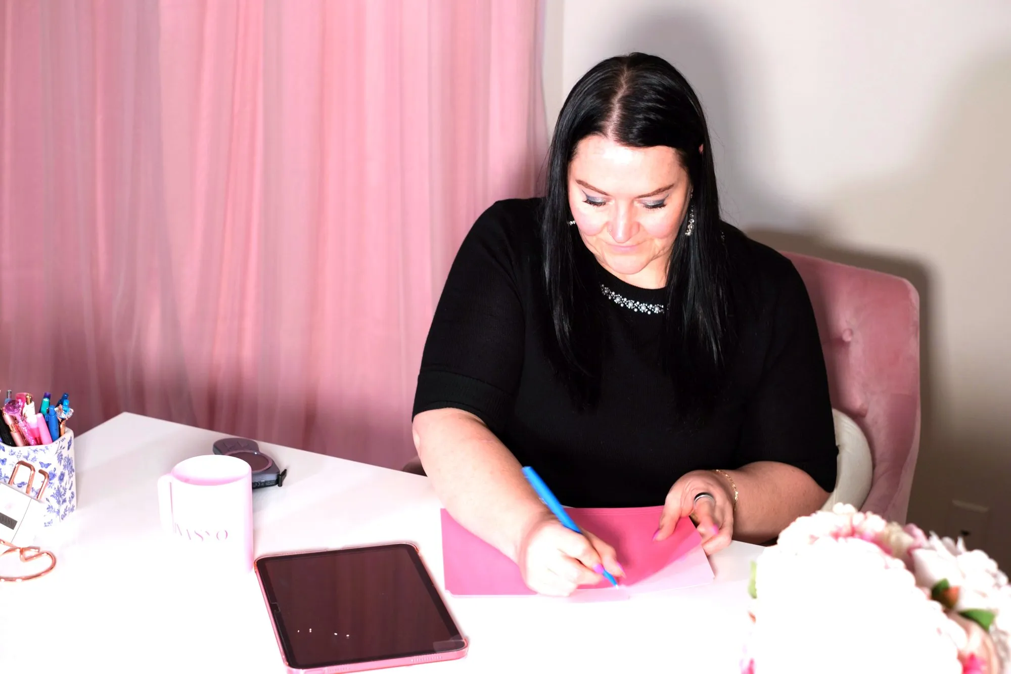Felina Brown, APRN, writing notes at her desk at Felina Sno Wellness